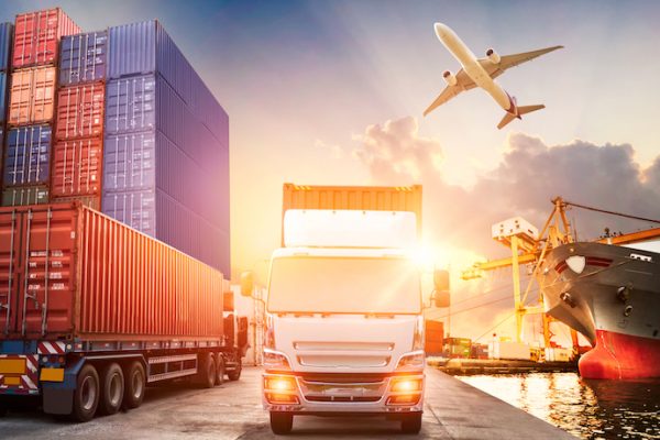 Logistics and transportation of Container Cargo ship and Cargo plane with working crane bridge in shipyard at sunrise, logistic import export and transport industry background
